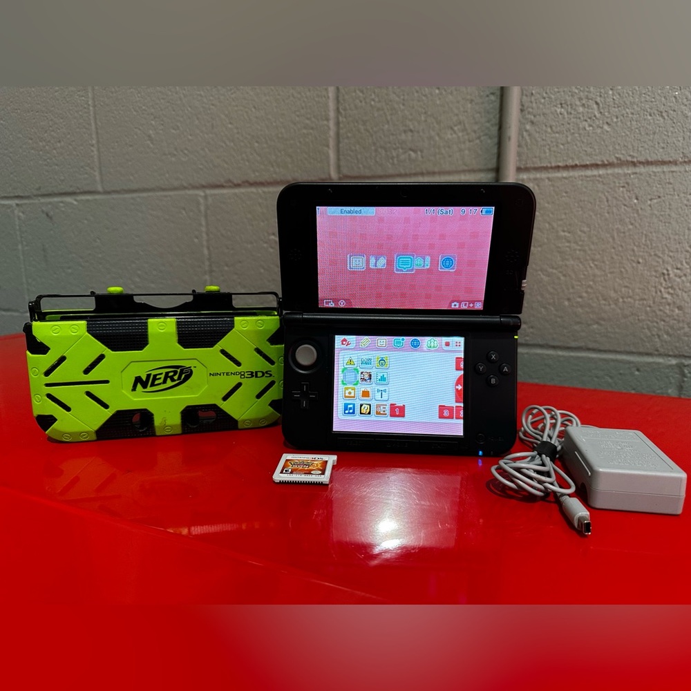 Nintendo 3DS XL black, Pokémon Sun game, and Nerf Armor